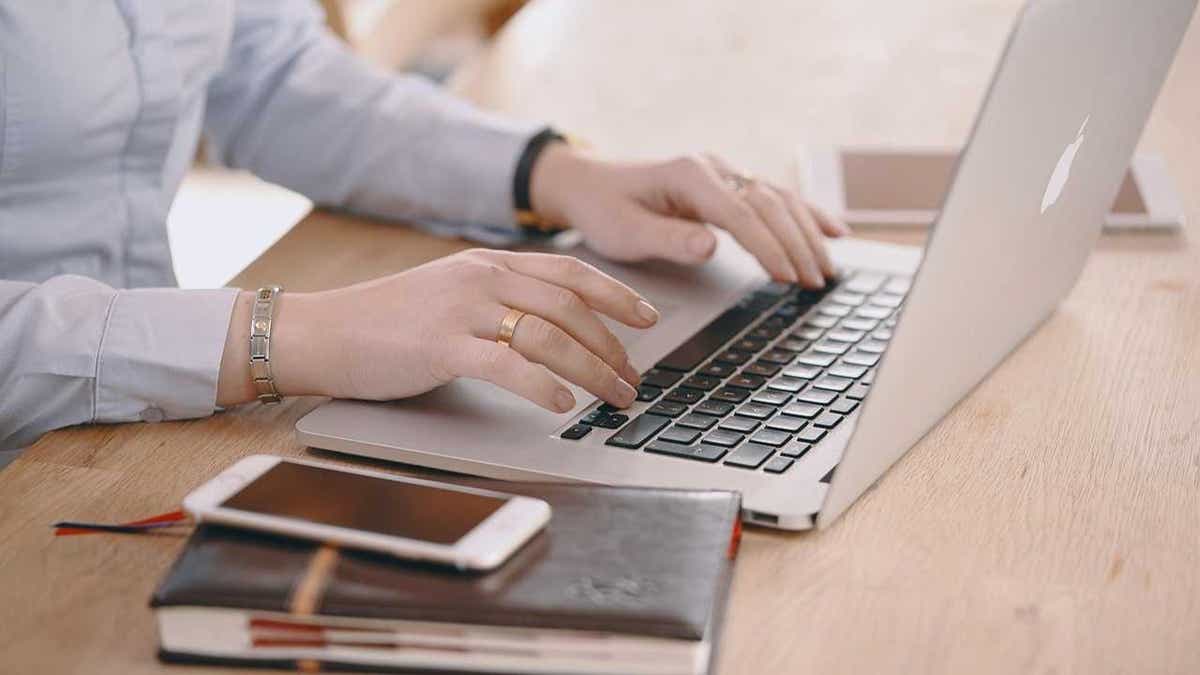 A woman booking airline travel on her laptop (Kurt "CyberGuy" Knutsson)